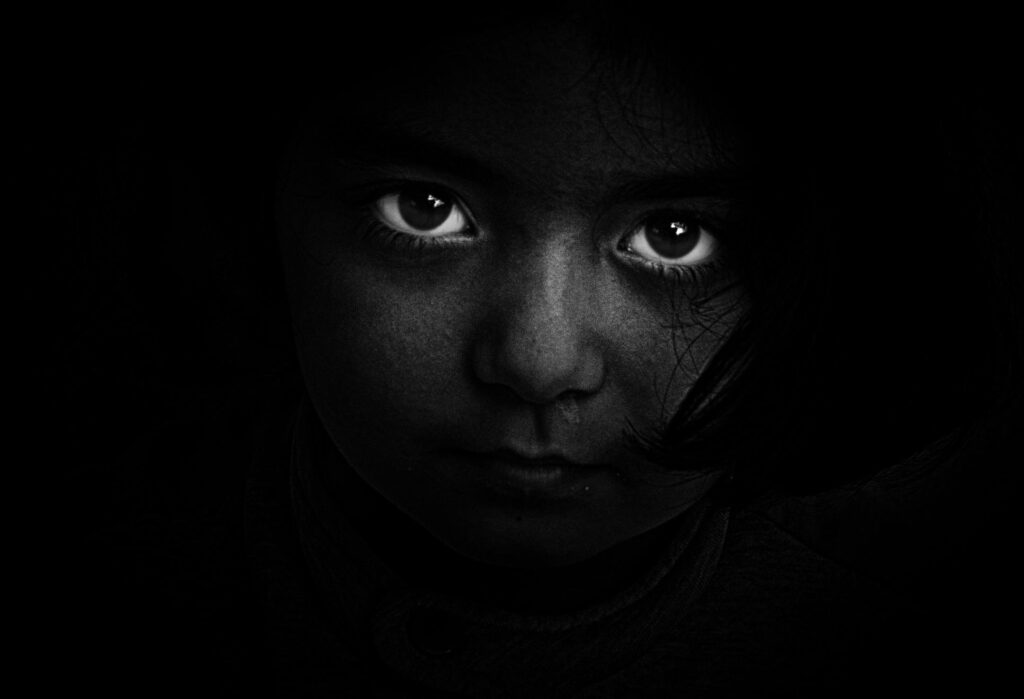 pexels-photo-18495 Intense black and white portrait of a child with captivating eyes, evoking mystery and emotion.
