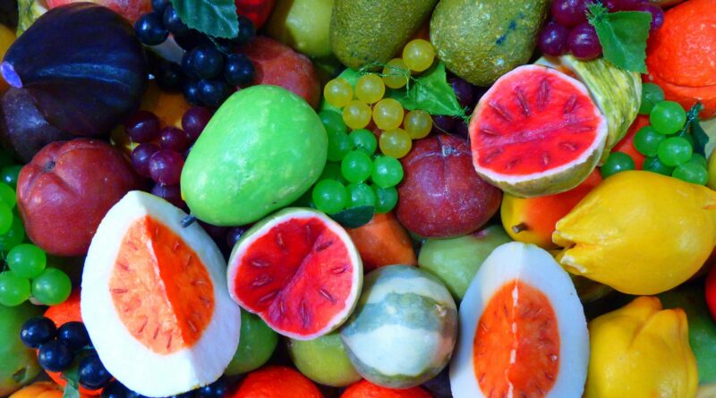 A diverse and vibrant array of colorful fruits, featuring various shapes and textures.